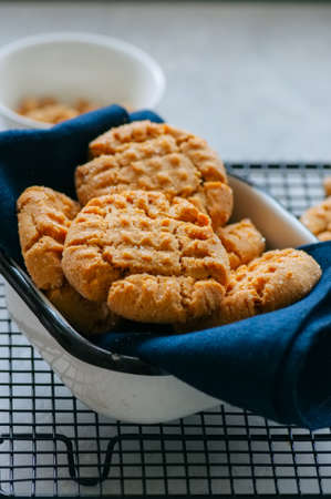 Homemade peanut butter cookies on a wire rack. Gray background. Rustic style.
