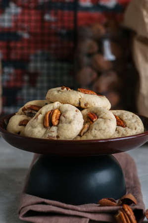 Chewy cookies with pecan nuts and brown sugar. Homemade baking concept.の写真素材