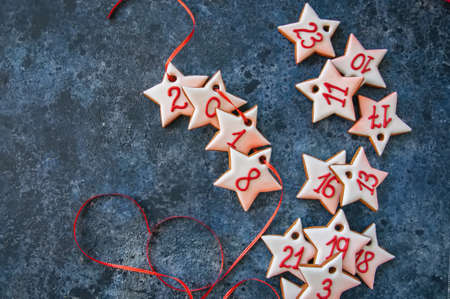 Advent gingerbread star cookies on a blue stone background.の写真素材