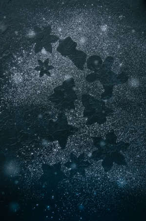 Different shapes of silhouettes on a black stone background.の写真素材