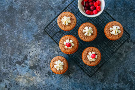 Brownie mins pies served on a wire rack on a blue stone background.の写真素材