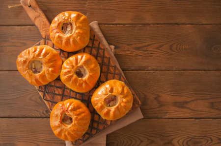 Group of individual pies with meat and potato - vak balish. Tatar traditional pies. Wooden background. Top view.の写真素材