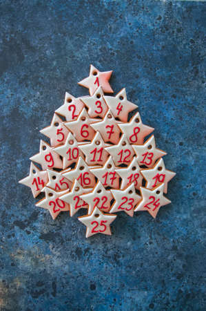 Advent gingerbread star cookies on a blue stone background.の写真素材