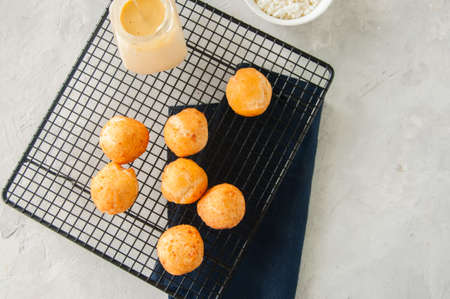 Small cottage cheese doughnuts (castgnole) with vanilla curd served in a vintage bowl.