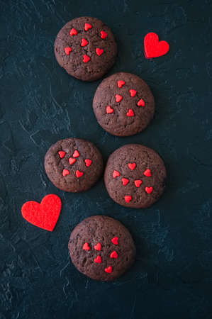 Chocolate cookies on a black stone backdrop. Saint Valentine's Day baclground.の写真素材