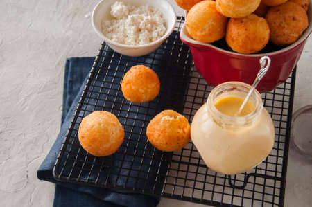 Small cottage cheese doughnuts (castgnole) served on a wire rack. 