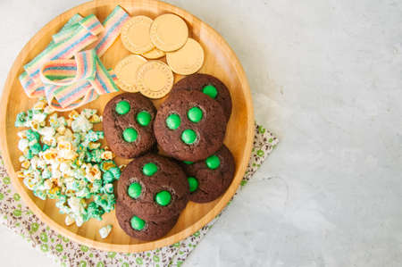 Sweet treats for St. Patricks day - Chocolate cookies, green popcorn, rainbow chewing marmalade and...