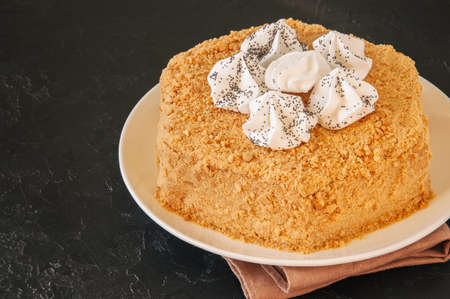 Honey cake with meringue decoration on top. の写真素材