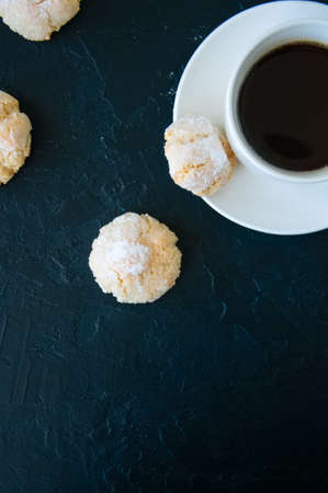 Cup of strong coffee and amaretti cookies on a black backgroundの写真素材