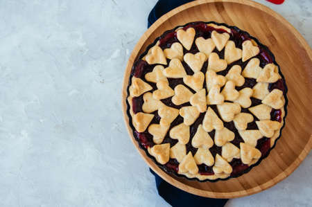 Cherry pie with heart shape decorations from flaky doughの写真素材