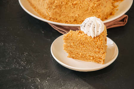 Honey cake with meringue decoration on top. の写真素材