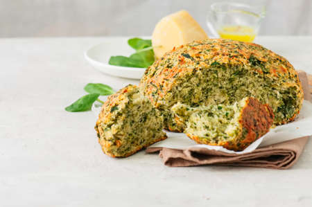 Freshly baked cheesy spinach bread on a white stone backdrop. Rustic style.の写真素材