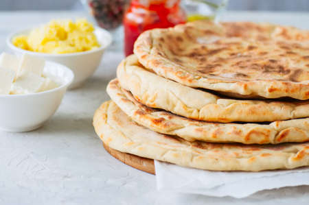 Mashed potato and sheep cheese filling flatbread on a white stone background.の写真素材