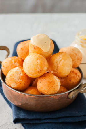 Small cottage cheese doughnuts (castgnole) in a bowl. White stone background.の写真素材