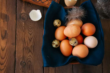 Fresh eggs in a plate on a wooden background. Stll life. Rustic style.の写真素材