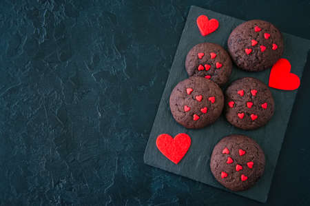 Chocolate cookies on a black stone backdrop. Saint Valentine's Day background.の写真素材