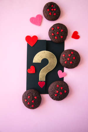 Chocolate cookies with hearts sugar on a pink background. Saint Valentine's Day concept.の写真素材