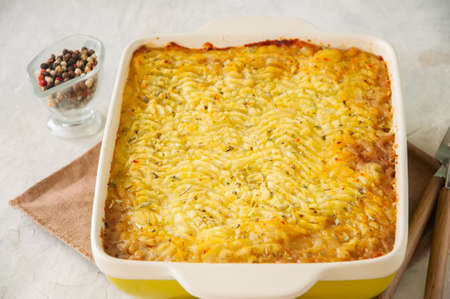 Shepherds pie -  Irish traditional food. Served in a ceramic dish on a white stone background.の写真素材