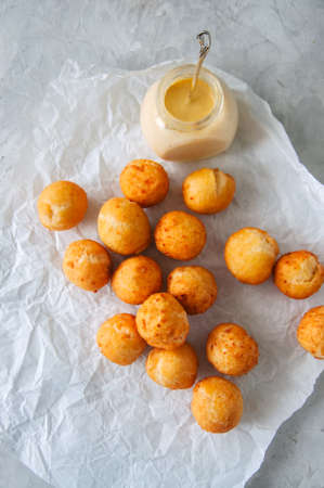 Fried cottage cheese doughnuts with vanilla sauce on a baking paper. Top view.の写真素材