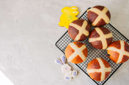 Chocolate and classic hot cross buns on a white stone background. Copy space.の写真素材