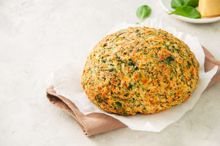 Freshly baked cheesy spinach bread on a white stone backdrop. Rustic style.の写真素材