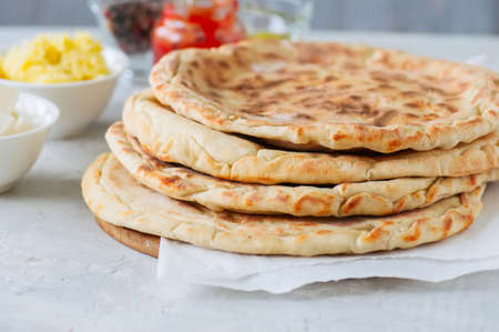 Mashed potato and sheep cheese filling flatbread on a white stone background.の写真素材