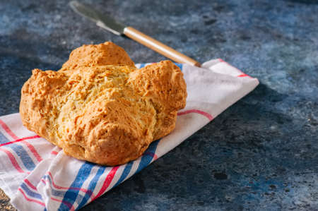 Traditional Irish soda bread on a towel on a blue stone background.の写真素材