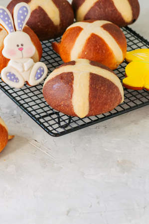 Homemade chocolate and classic hot cross buns with raisins on a white stone background. Copy space.の写真素材