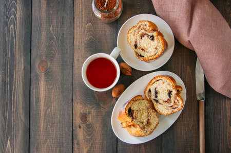 Reindling - Austrian or German festive yeasty baking for Easter. Brioche cake served in a plate and tea on a wooden stone background.の写真素材