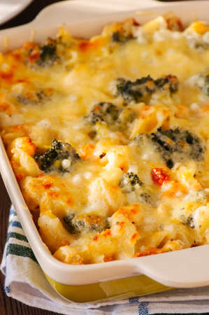 Close up of broccoli and pumpkin mac and cheese in a ceramic dish の写真素材