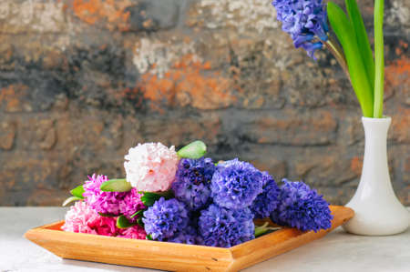 Group of hyacinth flowers in a wooden frame. Life style photo. Copy space.の写真素材