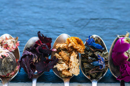 Various flavors of tea. Green tea flower tea matcha karkade in spoons. Close up.の写真素材