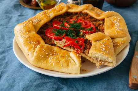 Saudi aysh abu laham or Saudi pizza or meat galette, traditional arabic and middle eastern food concept. の写真素材