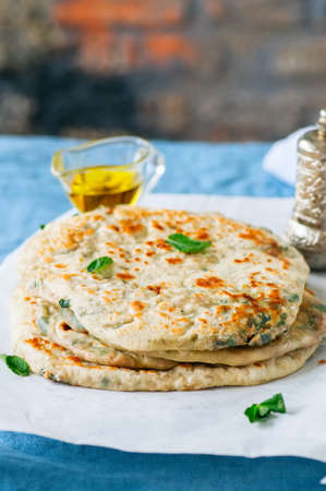 Indian flatbread - Herb stuffed paratha on a baking paperの写真素材