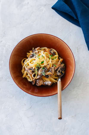 Italian food concept. Pasta with mushrooms and creamy sauce. Top view.の写真素材