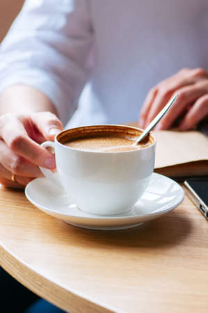 Woman holding a cup of coffee. Close up. Life style concept. Coffee break.の写真素材