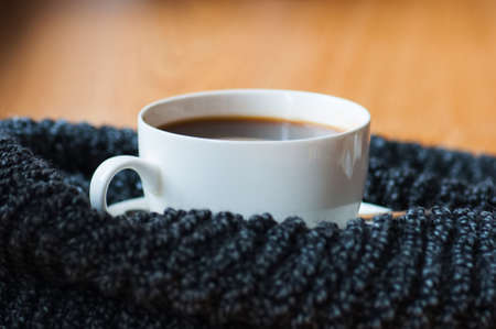 Cup of americano and scarf. Close up.の写真素材