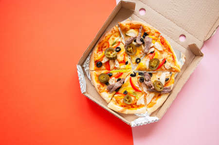 Pizza delivery concept. Hot pizza in a cardbox. Top view.の写真素材