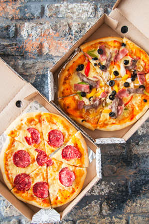 Pizza delivery concept. Hot pizza in a cardbox. Top view.の写真素材