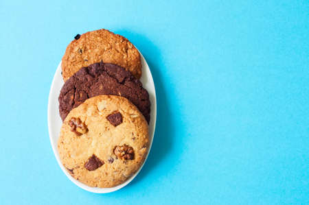 Three types of cookies in a plate on a blue background. Copy space.の写真素材