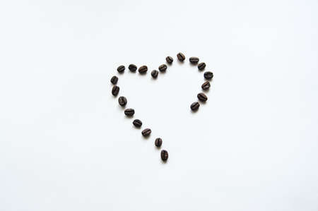 Heart shape from coffe beans. Top view. Isolatedの写真素材