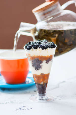 One portion of trifle dessert and green tea. Close up.の写真素材