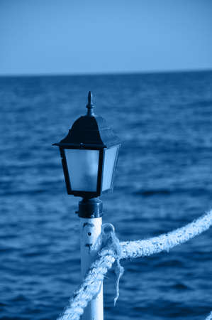 Close up of lantern on pier. Toned in trendy color of the year 2020.の写真素材
