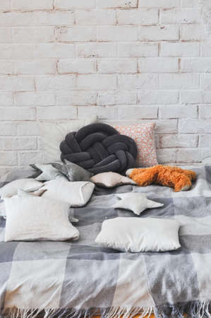 Cozy comfortable place for relax with pillows and plaid.