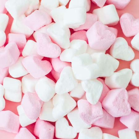 Pink fluffy heart shaped marshmallow background. Close up.の写真素材