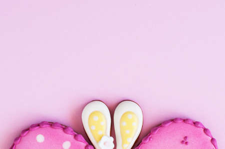 Easter background concept. Polka dot easter egg and bunny ear cookies on a pink background. Top...