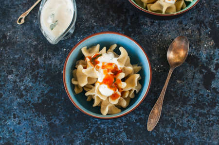 Turkish raviolli with tomato and yogurt sauces. Traditional Turkish food - ravioli filled with...