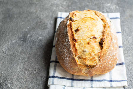 Freshly baked sourdough bread with dried tomatoes. Close up.の写真素材