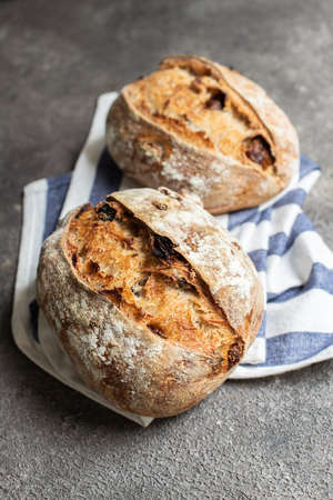 Freshly baked sourdough bread with dried tomatoes. Close up.の写真素材