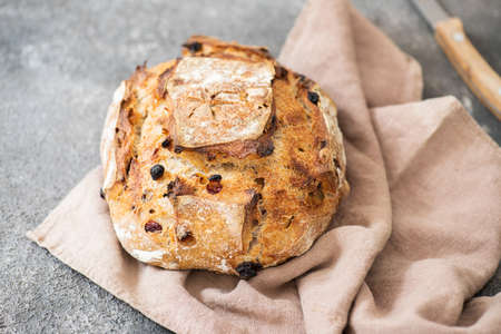 Sourdough dessert bread with dried apricots and walnuts on a napkin.の写真素材